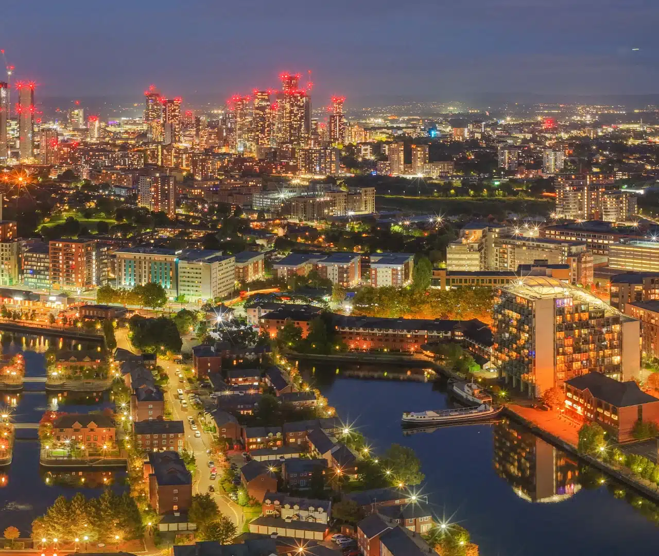 Night view of city skyscrapers and river lights.