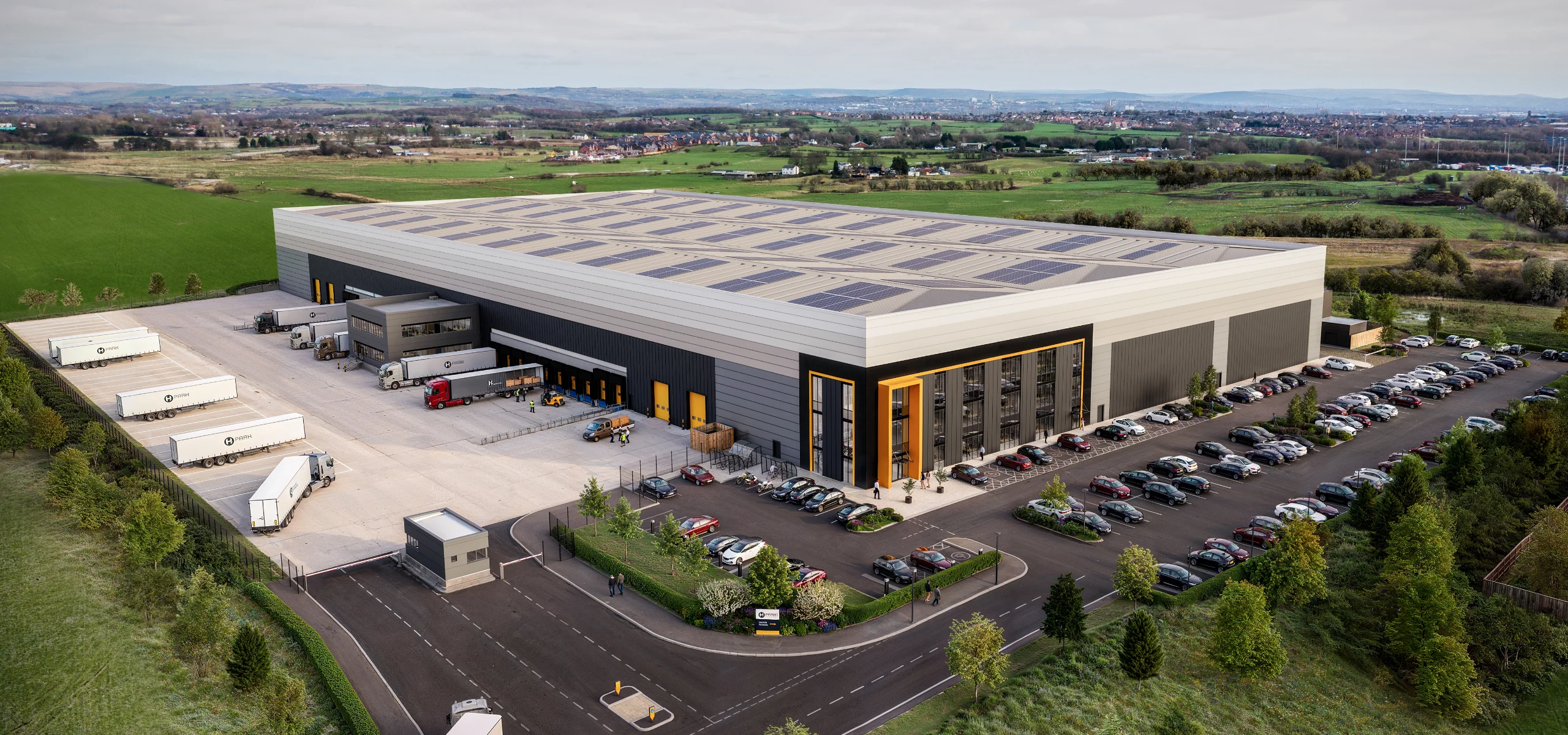 Modern warehouse with solar panels and parking