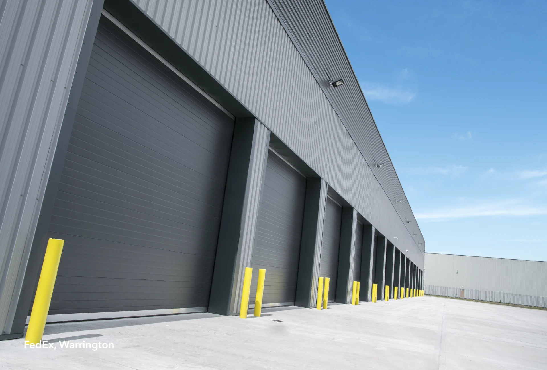FedEx Warrington depot loading bays with yellow bollards